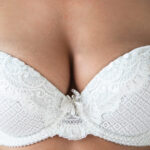 Young woman with natural breast wearing white bra